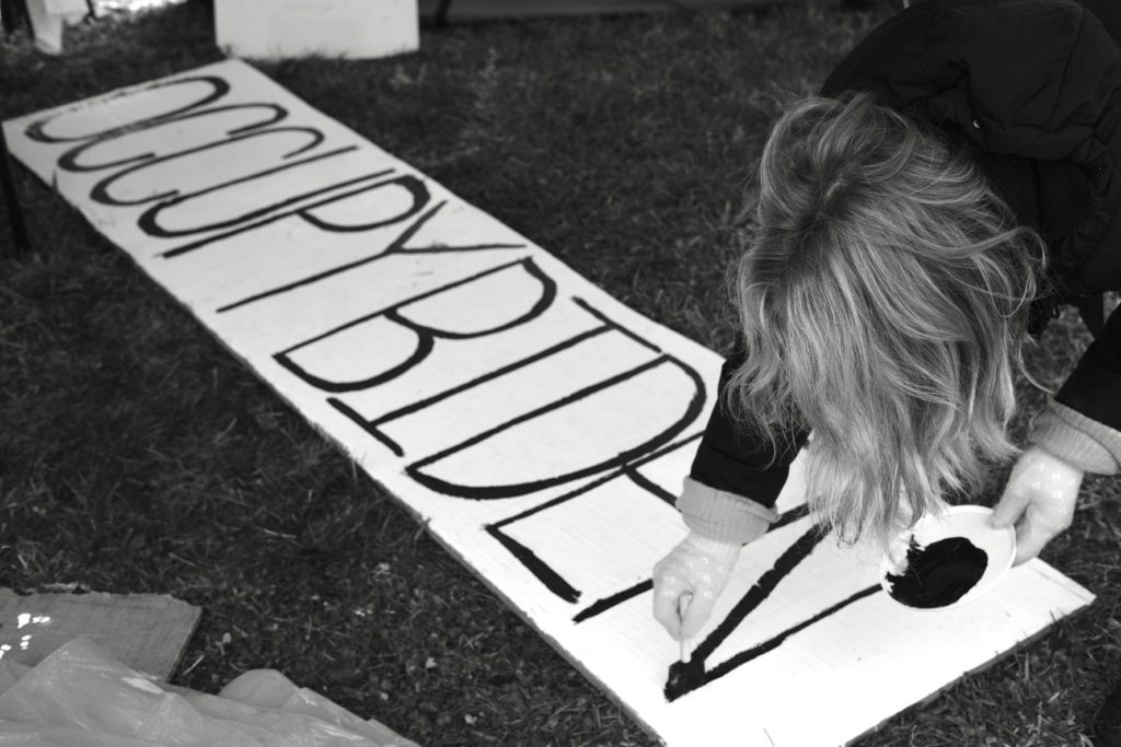 Painting an Occupy Biden sign