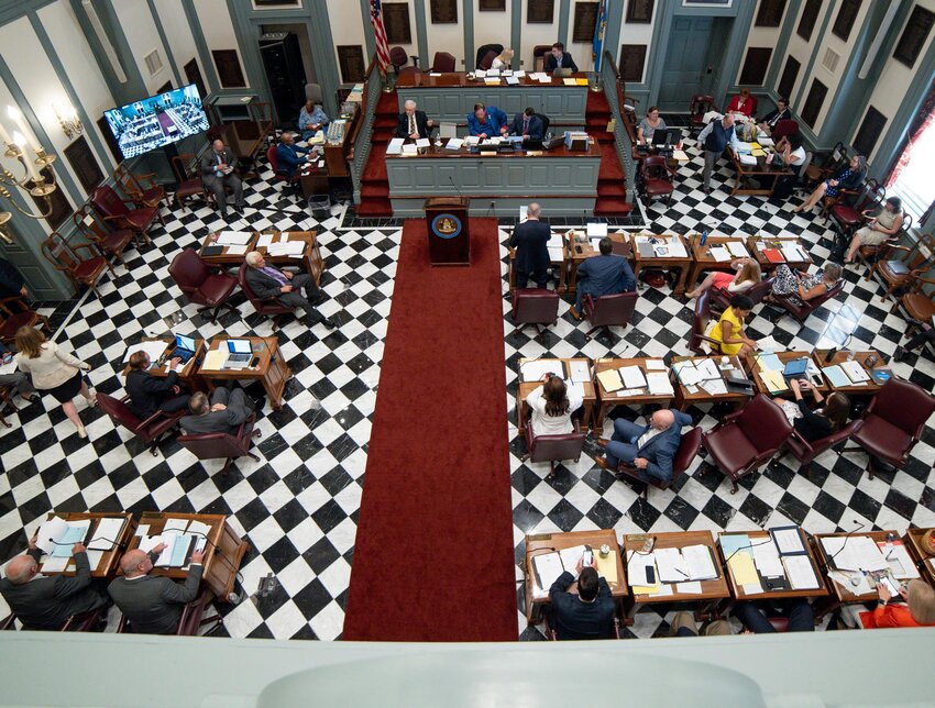 Legislators working on the floor of the Delaware General Assembly