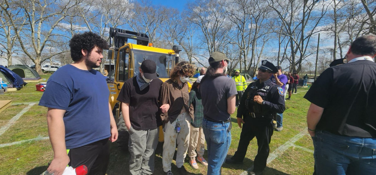 Activists block the move of homeless neighbors into small plots and city-issued tents at Christina Park on April 1, 2026.