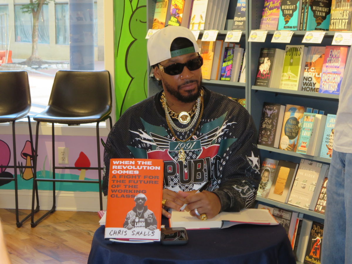 Smalls signs copies of his book at Huxley and Hiro in Wilmington.