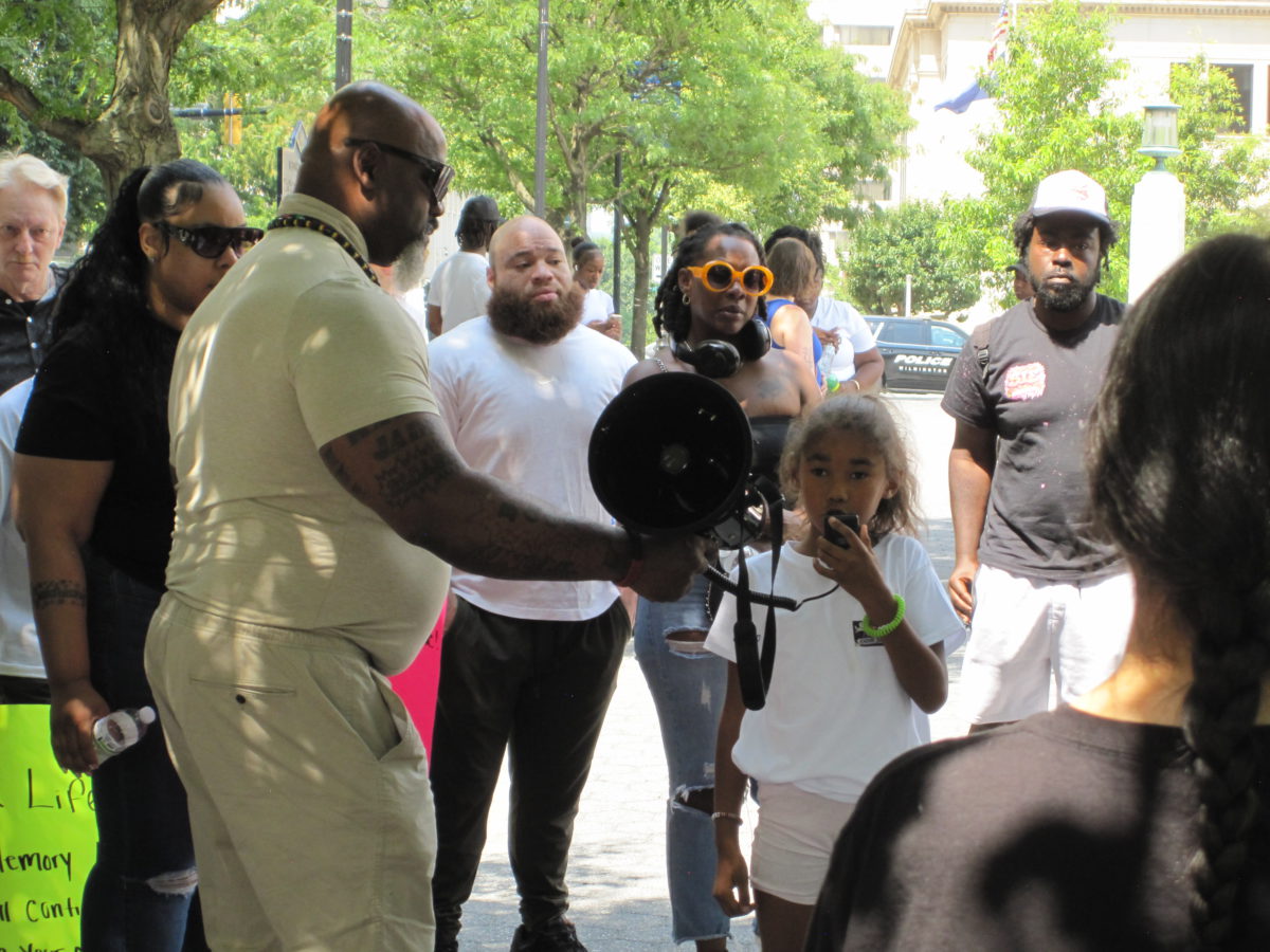 A family member of Kadir Skinner speaks at the July 12 rally at Rodney Square in Wilmington